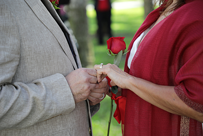 Couple holding hands during Valentine's Day Group Wedding.