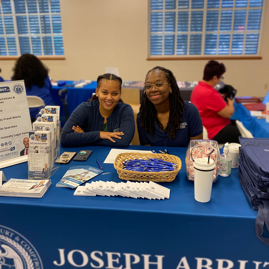 Clerk staff at table with Clerk services information