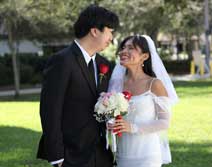 Couple in wedding attire smiling at each other