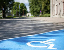 Closeup of a accessible parking space, blue and white symbol.